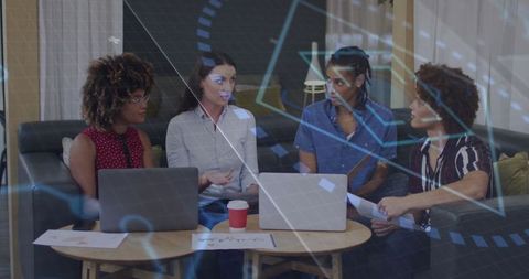 Diverse Team Collaborating in Office Lounge with Technology Overlay