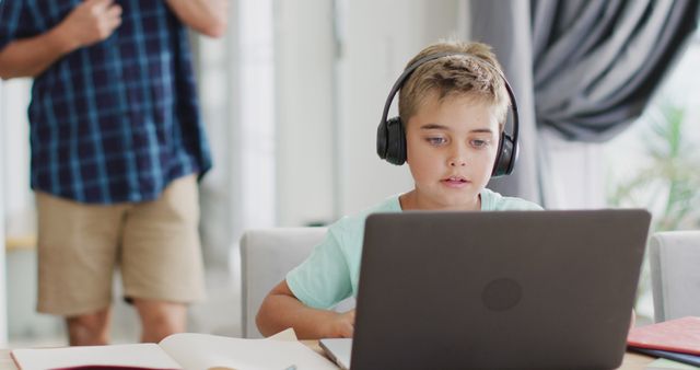 Young Boy Learning Online with Headphones and Laptop at Home - Download Free Stock Images Pikwizard.com