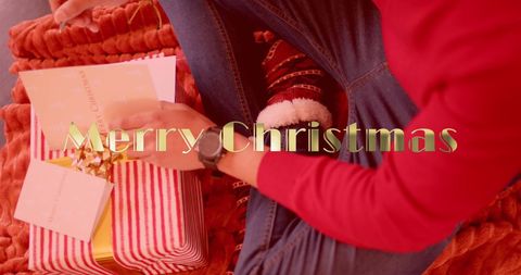 Man writing christmas cards with presents during holidays