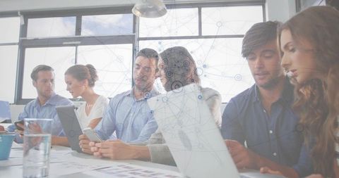 Team Collaborating on Digital Devices in Modern Office with Data Network Overlay