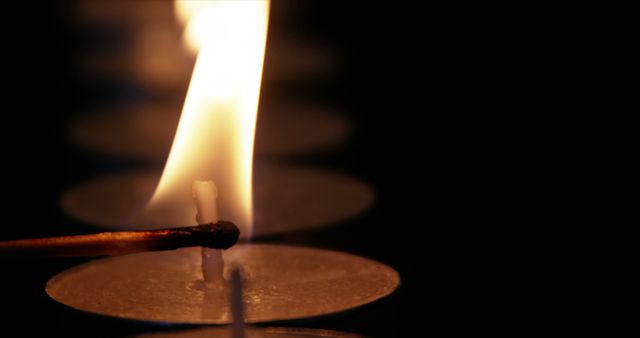 Lighting Candle Rows in Darkness with Matchstick Flame - Download Free Stock Images Pikwizard.com