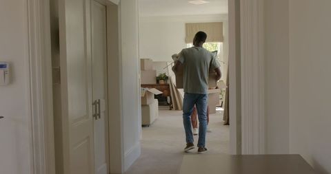 Couple unpacking in new home excitedly organizing belongings