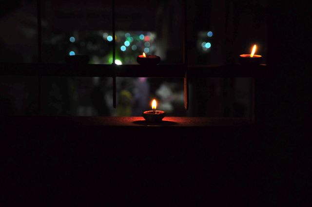 Candles floating in darkness symbolize festive celebrations and spiritual devotion, popular in Indian festivals like Diwali. Can be used in articles and advertisements promoting cultural events, spirituality, or festive decorations.