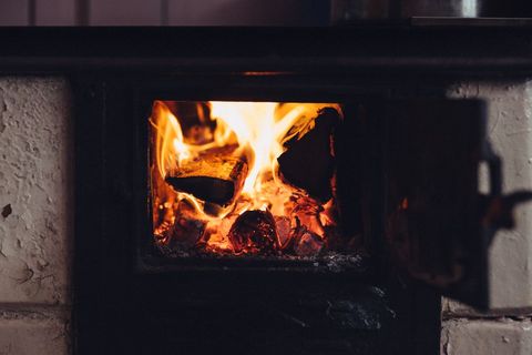Cozy warmth of wood-burning stove fire