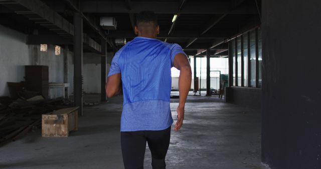 Determined Athlete Jogging in Abandoned Warehouse - Download Free Stock Images Pikwizard.com