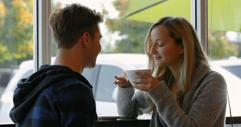 Young Couple Enjoying Coffee in Cozy Café Ambiance - Download Free Stock Images Pikwizard.com