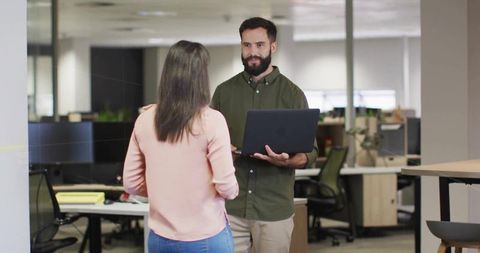 Professional Male Collaborating with Female Colleague in Modern Office