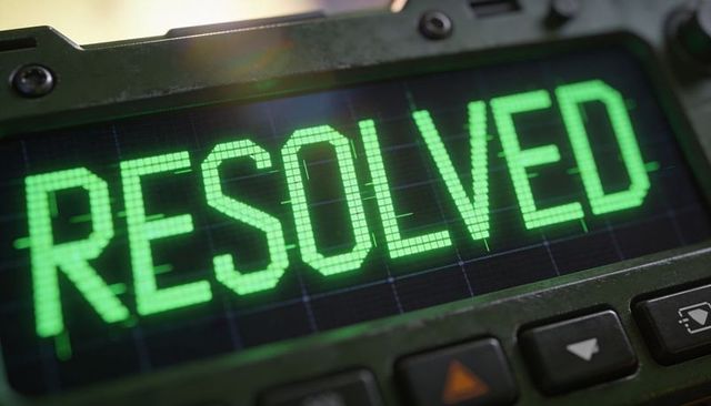 Rugged tactical console displaying green resolved message on durable handheld field device