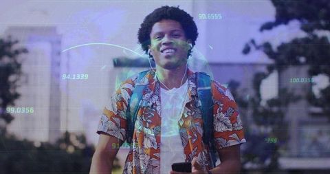 Tech-savvy young man walking in urban environment with data visualization overlay