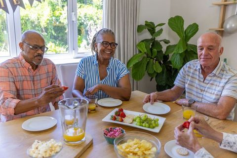 Senior friends enjoying leisurely snack and juice gathering