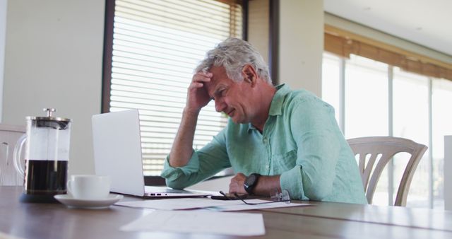 Stressed senior caucasian man with laptop calculating finances at home - Download Free Stock Photos Pikwizard.com