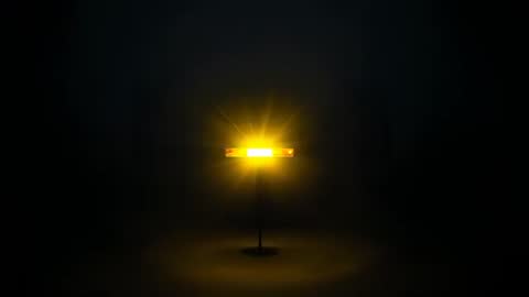 Rectangular Lamp Powering On Emitting Warm Starburst Rays and Halo Glow in Dark Studio