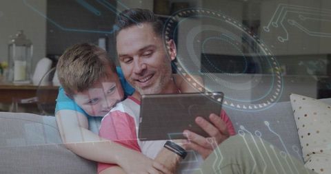 Father and son bonding on tablet with futuristic hud overlay, home family technology