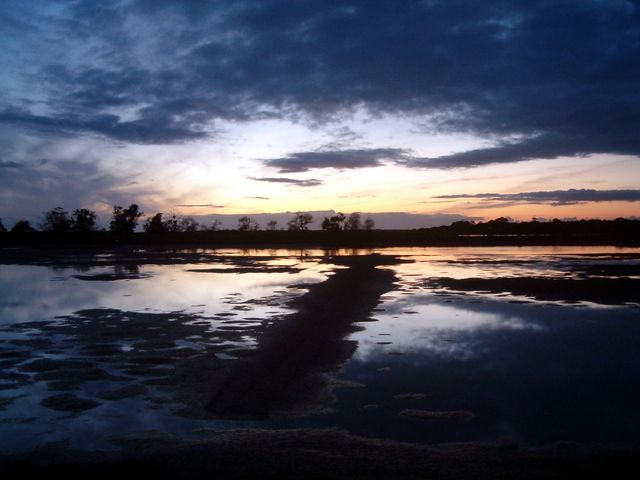 Dramatic Sunset Over Calm Lake with Cloud Reflections - Download Free Stock Photos Pikwizard.com