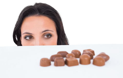 Brunette Peeking Curiously at Tempting Chocolates on Transparent Background
