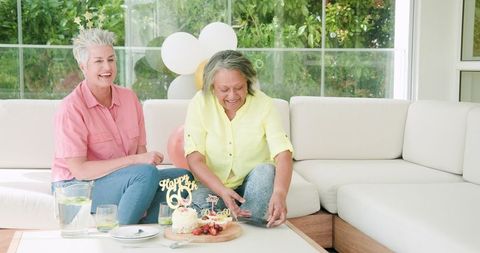 Senior Lesbian Couple Celebrating Birthday with Cake