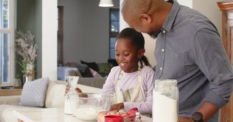 Father-Daughter Baking Moment in Cozy Home Kitchen