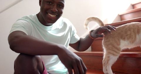 Joyful Bonding with Cat on Wooden Staircase at Home