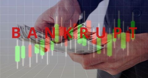 Bankrupt warning showing on falling candlestick chart while businessman counting us dollars
