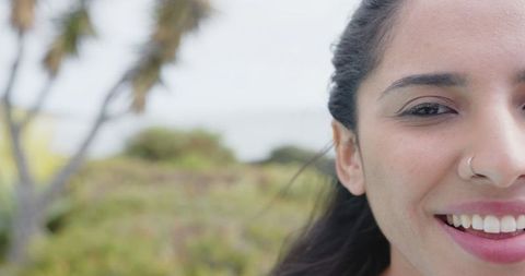 Young indian woman smiling outdoors with nose ring