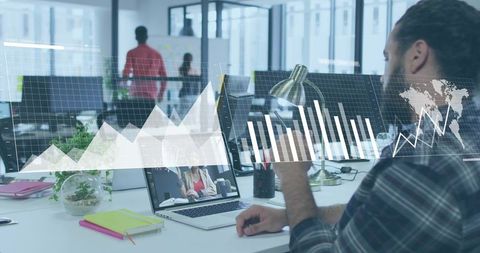Male office worker analyzing digital graphs in modern workspace, collaboration insight