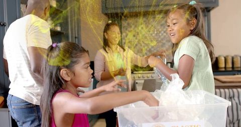 Children sorting plastic bottles in kitchen, family recycling teaching sustainability