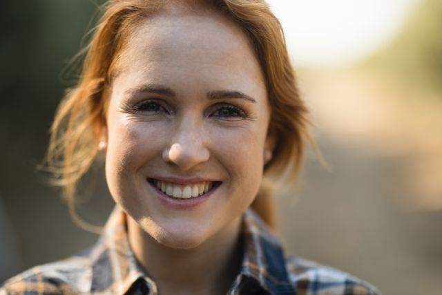 Close up portrait of smiling young woman at farm 