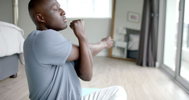 Young Man Stretching Arms in Living Room, Morning Routine for Fitness and Wellness - Download Free Stock Images Pikwizard.com