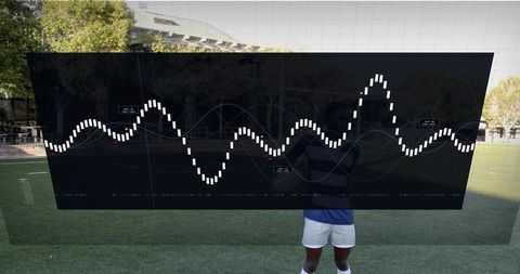 Transparent tactical display showing waveform overlay on athletic field with player