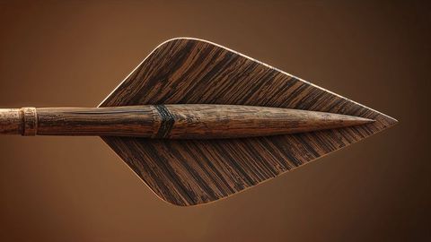Handcrafted wooden arrow with carved tip and rustic design