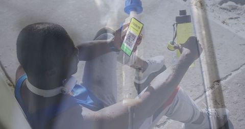 Man registering covid-19 vaccine with smartphone app sitting with medical supplies