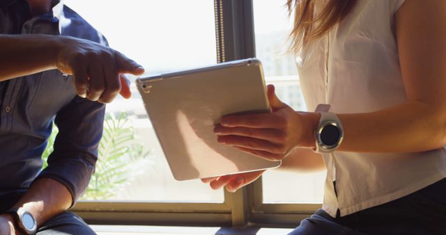 Coworkers Collaborating on Tablet in Bright Natural Light - Download Free Stock Images Pikwizard.com