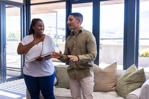 Couple enjoying bright living room with urban skyline view