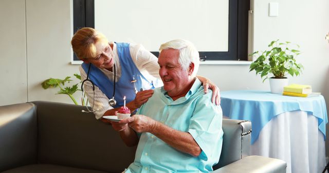 Nurse Celebrating Elderly Man's Birthday in Healthcare Facility - Download Free Stock Images Pikwizard.com