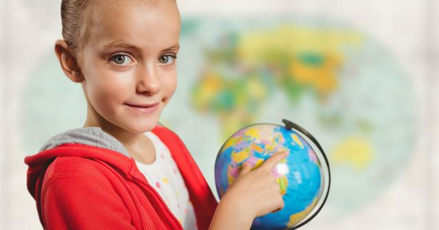 Digital composite of Girl with globe against blurry map