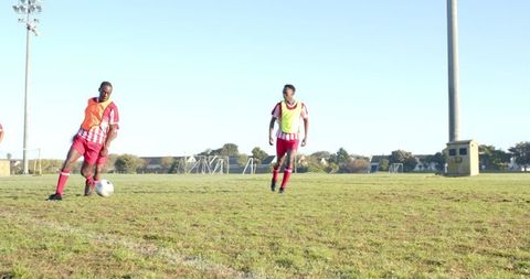Youth Soccer Players Dribbling Ball During Outdoor Training Session