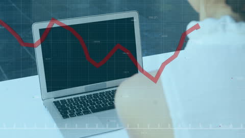 Businesswoman Analyzing Financial Data on Laptop with Declining Graph