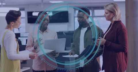 Diverse Team Collaborating in Modern Open Office with Technology