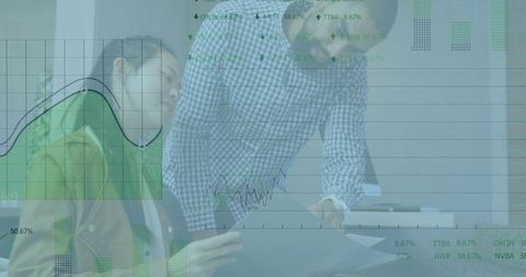 Reviewing reports with overlaid analytics charts during collaborative office meeting
