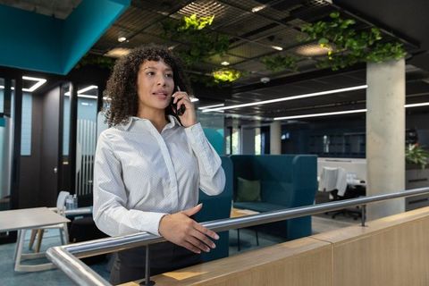 Business professional engaging on phone in modern office space