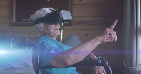 Senior Woman in Wheelchair Using Virtual Reality Headset