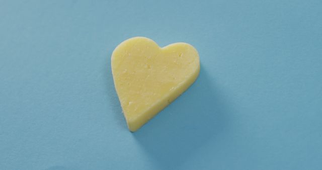 Yellow Heart-Shaped Object on Light Blue Background - Download Free Stock Images Pikwizard.com