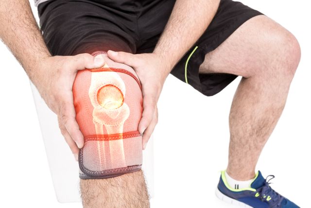 Mid section of man holding sore knee - Download Free Stock Photos Pikwizard.com