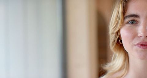 Serene half-face portrait of elegant woman in soft stroking light