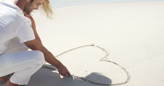 Couple Drawing Heart in Sand on Sunny Beach - Download Free Stock Images Pikwizard.com