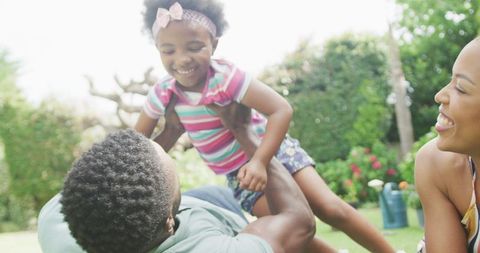 Happy Family Bonding in Garden with Supporting Parents