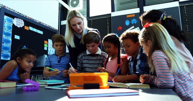 Teacher Guiding Diverse Group of Students in Classroom Activity - Download Free Stock Images Pikwizard.com