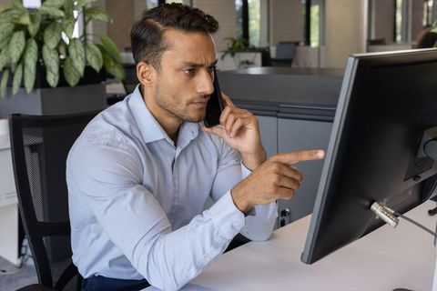 Focused Professional Discussing Business on Smartphone