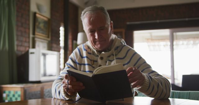 Senior Man Reading Book in Cozy Home Environment - Download Free Stock Images Pikwizard.com