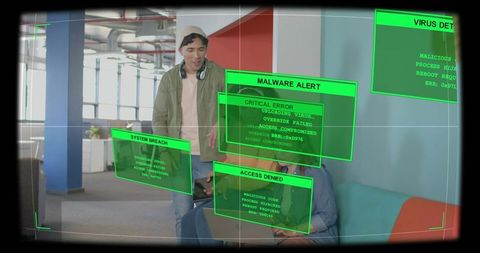 Leaning beanie man guiding colleague at laptop amid malware alerts and ar breach overlays